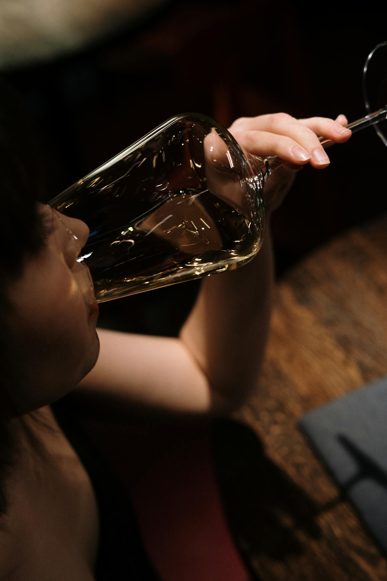 a woman drinking from a wine glass